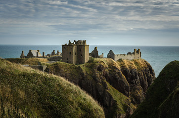 Fototapeta na wymiar View of the Dunnottar Castle on the top of the hill in a cloudy day, Stonehaven, Scotland, United Kingdom