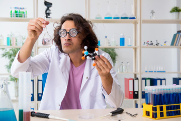Funny male chemist working in the lab