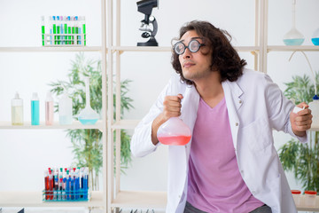 Funny male chemist working in the lab