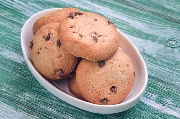 Delicious sweet snack. Cookies with chocolate on a white plate.