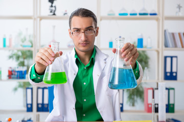 Young male chemist teacher in the lab