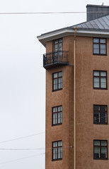 Brown Scandinavian apartment building with a nice balcony