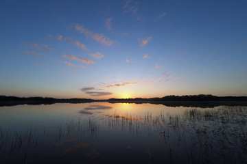 Colorful sunrise clouds and reflections on Nine Mile Pond in Everglades National Park, Florida in winter.