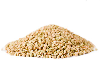 Heap of green buckwheat groats isolated on a white background.