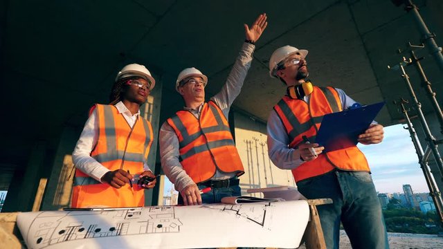 Team of architects are discussing plans for constructions