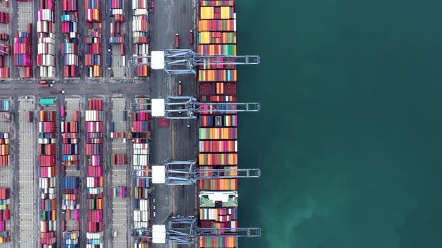 Aerial top view car carrier vessel at night, rows of new cars at night waiting to be dispatch and shipped import export new cars.