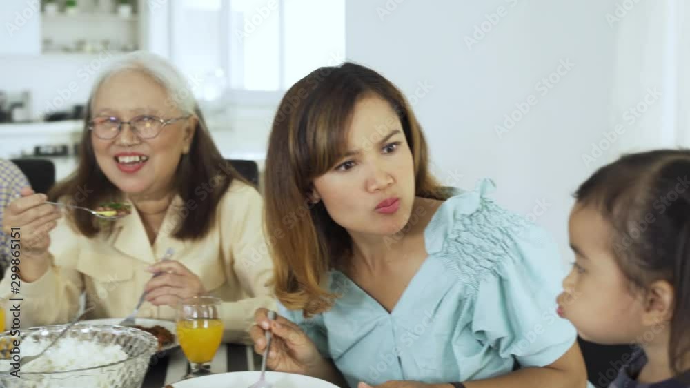 Sticker happy three generation family having lunch together in dining room at home. shot in 4k resolution