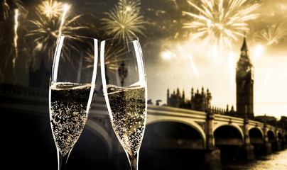 celebrating new year's eve in the city - toasting with champagne glasses in front of Big Ben-...