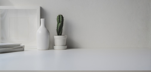 Minimal office room with copy space and decorations on white wooden table