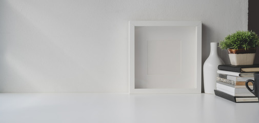 Fototapeta na wymiar Minimal office room with copy space and decorations on white wooden table