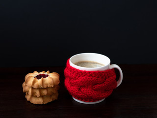 The cup wrapped in the red skarf