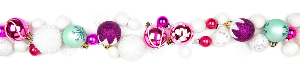 Christmas border of purple, pink and teal decorations. Top view isolated  on a white background.