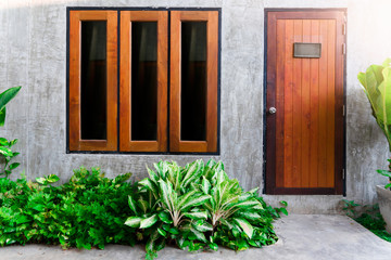 Wooden door and window with small garden at home.  Interiors concept