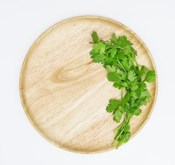 coriander on wooden dish,isolated on white background,top view