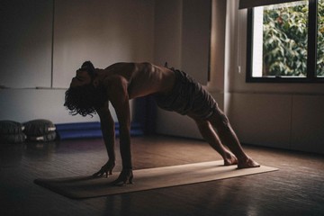 man doing yoga at studio