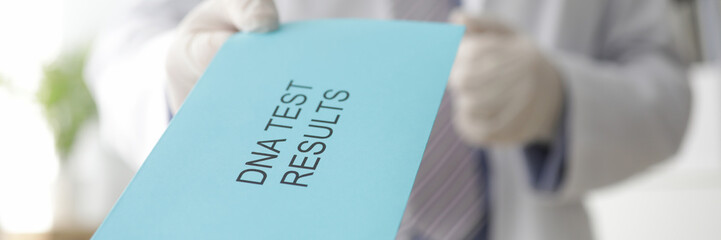Male doctor hand holds out an envelope