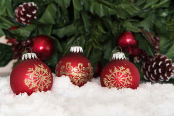 Fototapeta na wymiar Red Christmas baubles in snow. Holiday Theme.