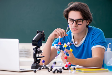 Young male student in the classroom