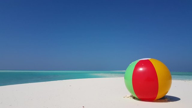 Pulau Bruit, Malaysia, tropical vacation background.Colorful beach ball standing on white sand