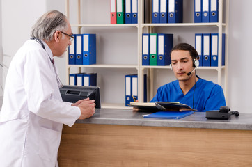 Two doctors talking at the reception in hospital