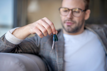 Close up of man holding keys from his own apartment