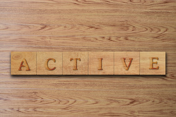 Active word letters on wood block. message text on wooden table for backdrop design.