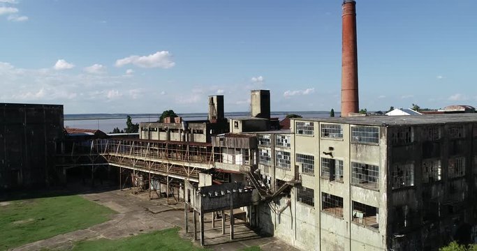 Aerial drone scene of old abandoned insdustry, flying towards rusty staircase and broken windows. The Anglo, Unesco, Fray Bentos, Uruguay