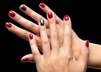 Hands of a girl with red manicure