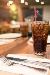 cola water and ice in glass at restaurant