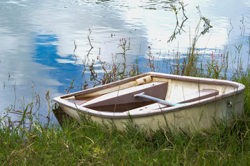 Naklejka na ściany i meble Half sunk boat on a shore