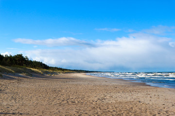 Storm on the baltic sea under bright blue sky