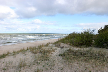 Fototapeta na wymiar Waves, blue sky and baltic sea sand dunes, Palanga, Lithuania