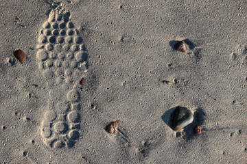 footprint of the sneaker in the sand close up