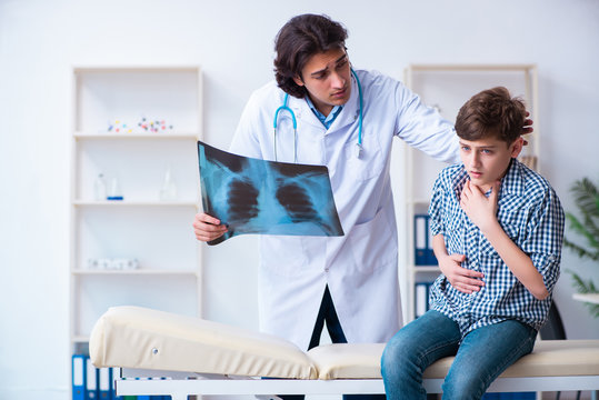 Male radiologist looking at boy's images