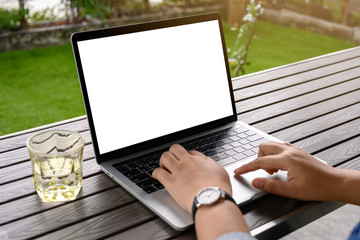 Blank screen laptop computer on wood table with clipping path. business concept. Mockup with copy space.