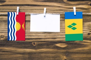 Hanging flags of Kiribati and Saint Vincent And The Grenadines attached to rope with clothes pins...