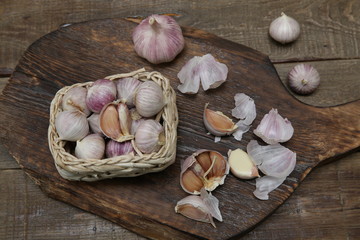 organic garlic in a basket and garlic on a wooden rustic board. Health concept. Top View, Flat Lay.