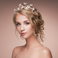 Young blonde woman with tiara on her head. Blonde girl with elegant and shiny hairstyle. Beautiful...