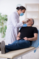 Old man visiting young doctor for plastic surgery