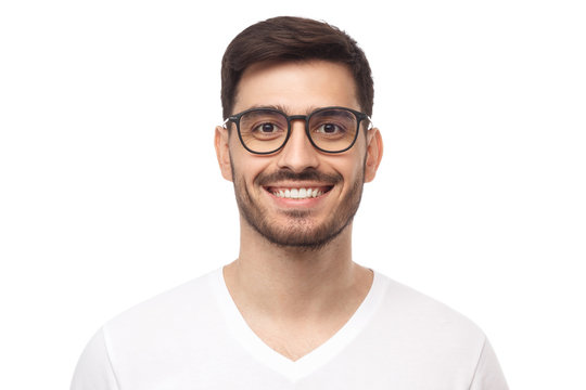 Smiling handsome young man in casual t-shirt, looking at camera, isolated on white background