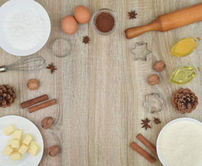 Tools and products for baking homemade gingerbread cookies on a wooden background. The concept of the holiday, celebration and cooking. Place for an inscription.