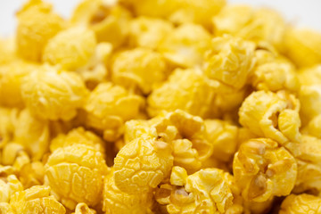 Butter caramel popcorn in wooden bowl bulk on white background, Popular snack with favorite movie