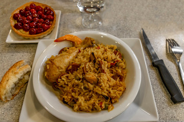 .Rice with chicken and seafood. Cake with cherries.
