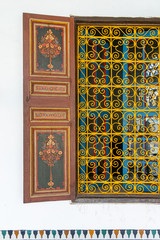 Detail of yellow decorative fence of a window of the Bahia palace in Marrakech. Morocco