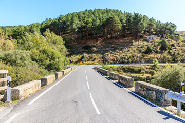 Highway with First fall colors in the mountains of Madrid, Spain