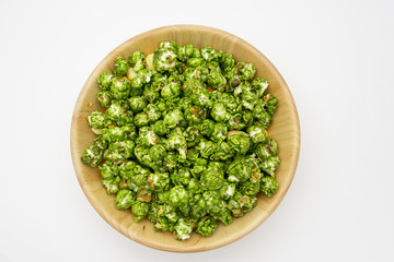 Top view the lush of Japanese matcha green tea popcorn with white background for copy space text, Popular snack with favorite movie