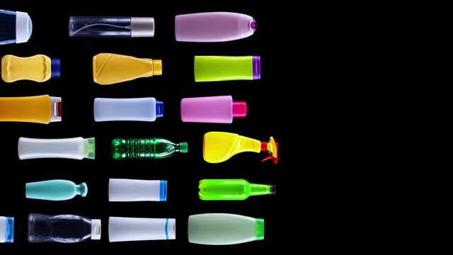 Plastic waste bottles filling the screen sliding through, pollution concept - stop motion like animation, black background