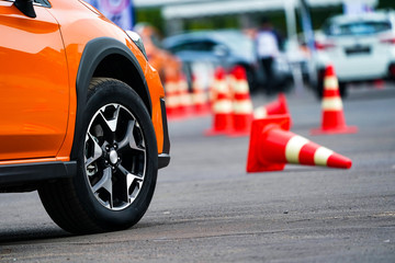 close up wheel of orange car on the road