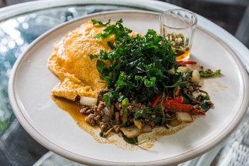 Close up stir fried minced pork with basil and fried egg
