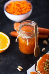 Carrot Jam with orange juice on a black background